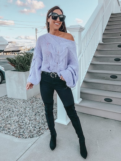 woman wearing purple sweater and black jeans