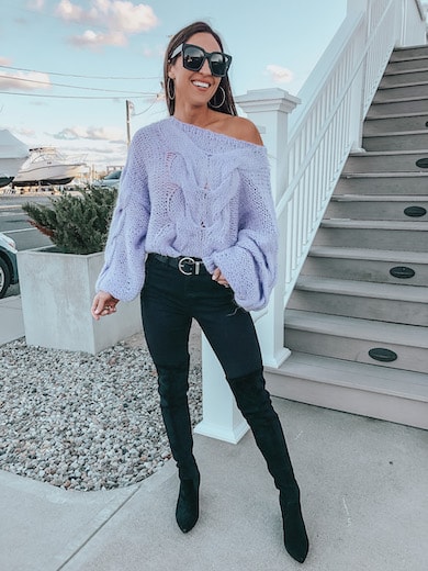 woman wearing purple sweater and black jeans