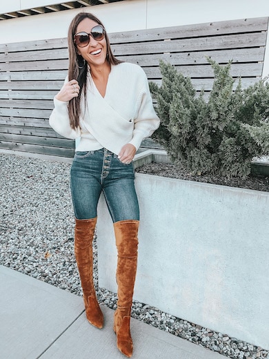 woman wearing white sweater and brown over the knee boots