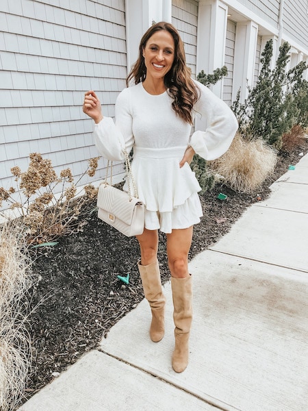 woman wearing romper with knee high boots